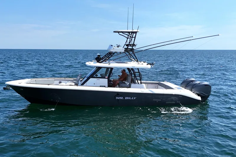 Slide: The Image of 2024 Everglades 395 Center Console boat on open water, side view. - 10