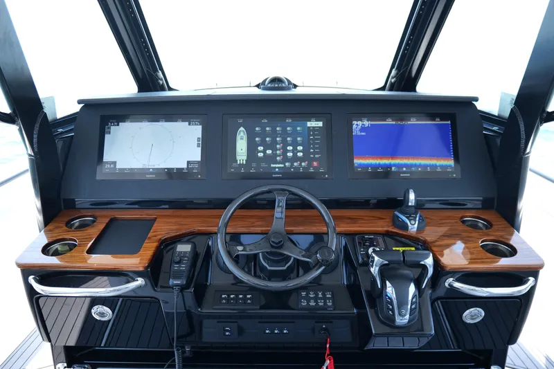Slide: The Image of 2024 Everglades 395 Center Console dashboard with advanced navigation displays and controls. - 12