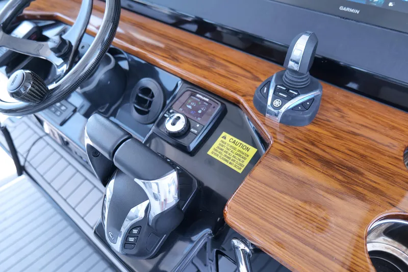 Slide: The Image of 2024 Everglades 395 Center Console helm with wood finish and modern controls. - 14