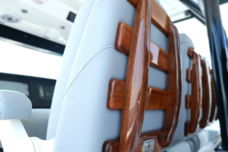 Slide: The Image of 2024 Everglades 395 Center Console interior with polished wood accents and sleek design. - 16