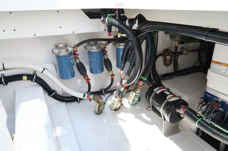 Slide: The Image of Engine compartment of 2024 Everglades 395 Center Console with visible filters and wiring. - 20