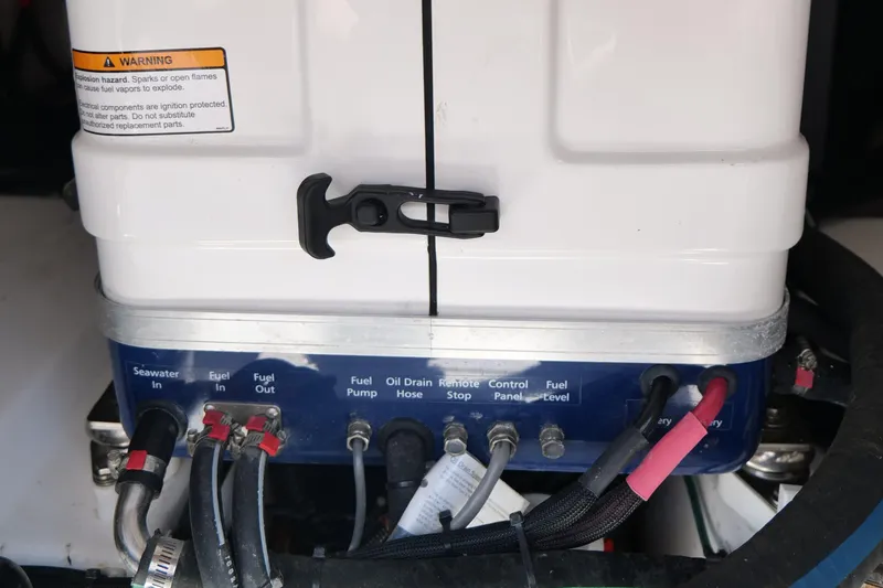 Slide: The Image of 2024 Everglades 395 Center Console engine compartment with labeled connections and warning label. - 21