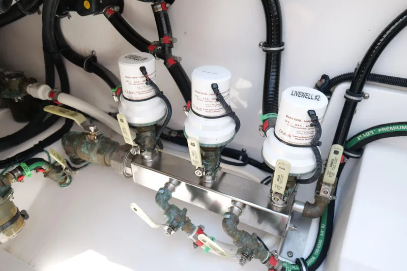 Slide: The Image of 2024 Everglades 395 Center Console livewell system with plumbing and valves. - 22