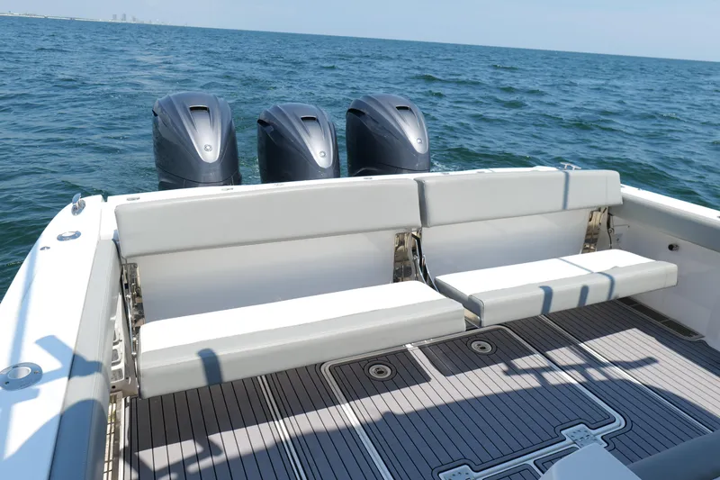 Slide: The Image of 2024 Everglades 395 Center Console boat with triple engines on open water. - 23