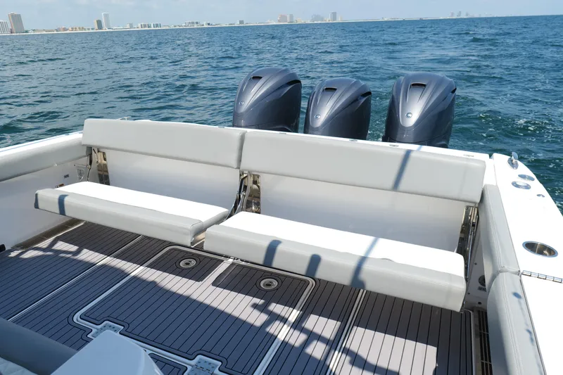 Slide: The Image of 2024 Everglades 395 Center Console boat with triple engines and spacious seating on open water. - 24