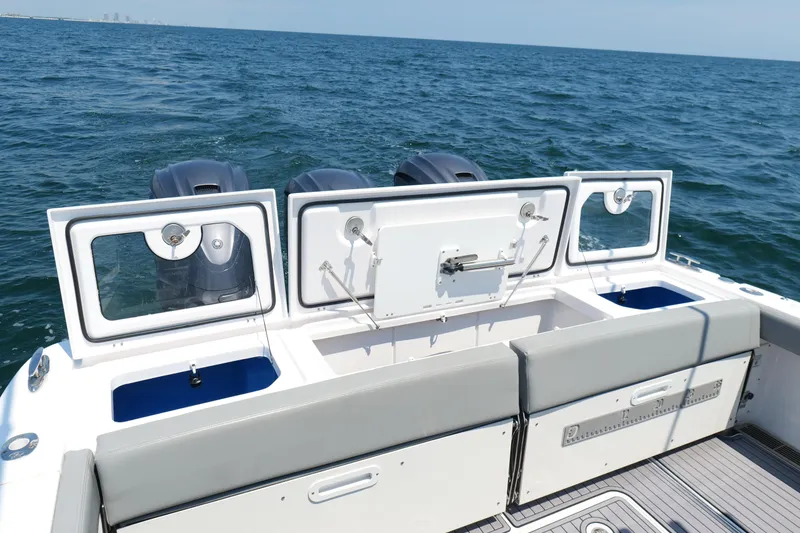 Slide: The Image of 2024 Everglades 395 Center Console boat with open storage compartments on the ocean. - 25