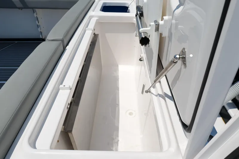 Slide: The Image of Open storage compartment on 2024 Everglades 395 Center Console boat. - 27