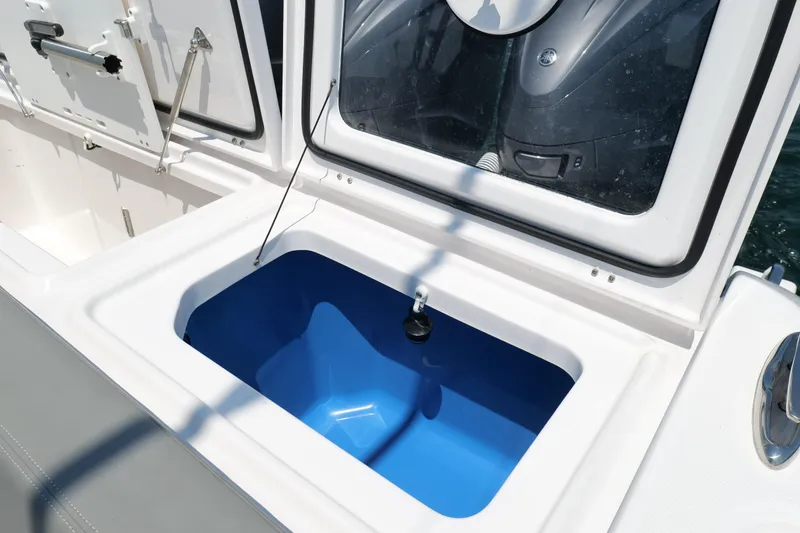 Slide: The Image of Open storage compartment on 2024 Everglades 395 Center Console boat. - 28