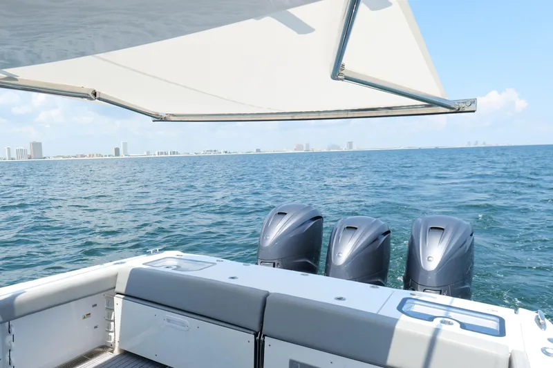 Slide: The Image of 2024 Everglades 395 Center Console boat with triple engines on open water. - 32