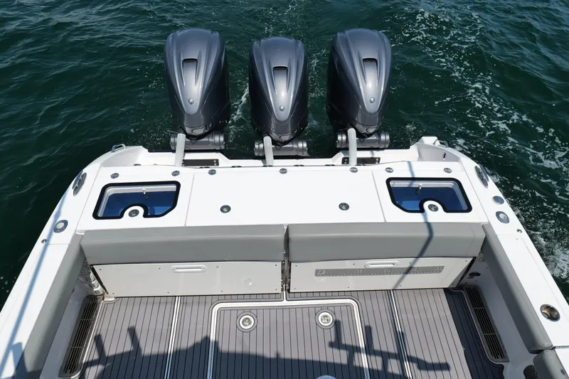 Slide: The Image of 2024 Everglades 395 Center Console boat with triple outboard engines on water. - 33