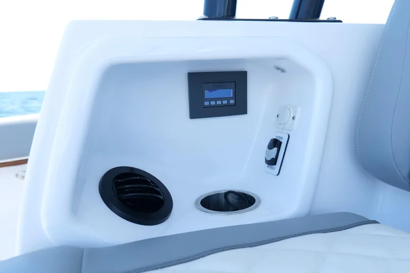 Slide: The Image of 2024 Everglades 395 Center Console dashboard with control panel and cup holder. - 36