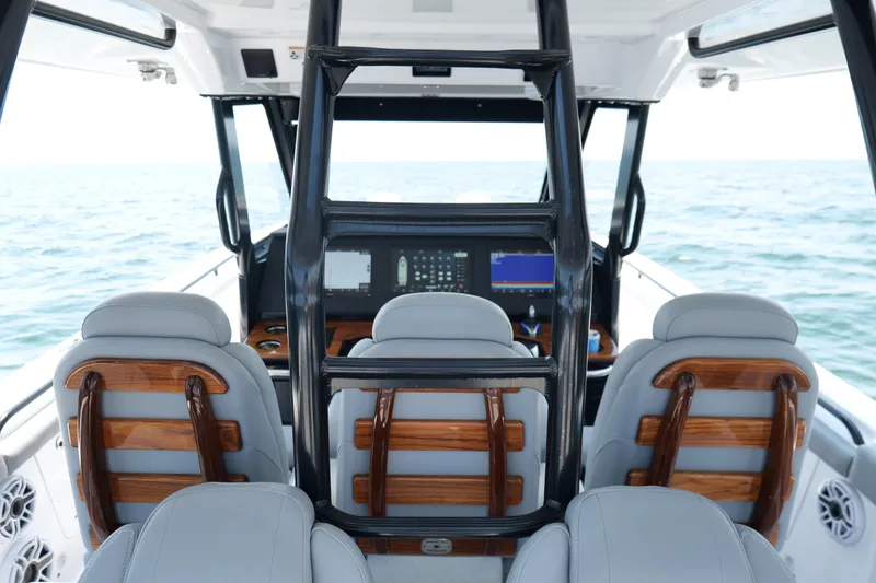 Slide: The Image of 2024 Everglades 395 Center Console interior with modern helm and seating, ocean view. - 37