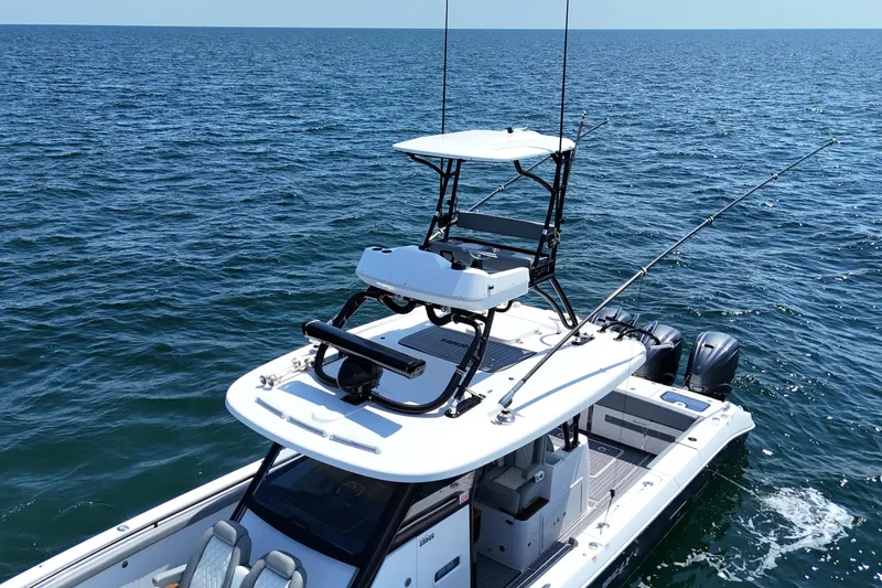 Slide: The Image of 2024 Everglades 395 Center Console boat on open sea, featuring dual outboard motors. - 40