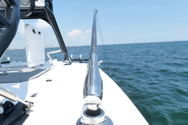 Slide: The Image of 2024 Everglades 395 Center Console boat on open water, showcasing sleek design and chrome details. - 43