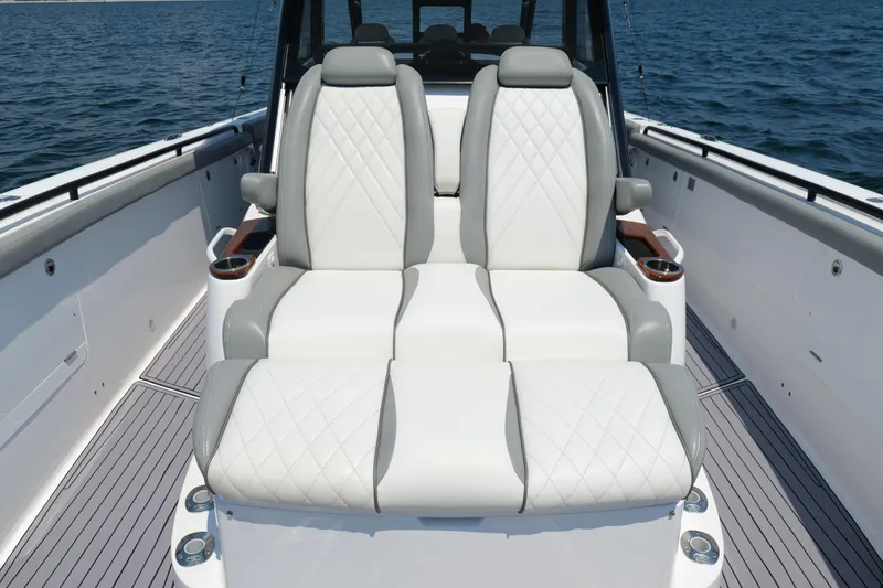 Slide: The Image of Luxurious seating on 2024 Everglades 395 Center Console boat, featuring elegant white and gray upholstery. - 48