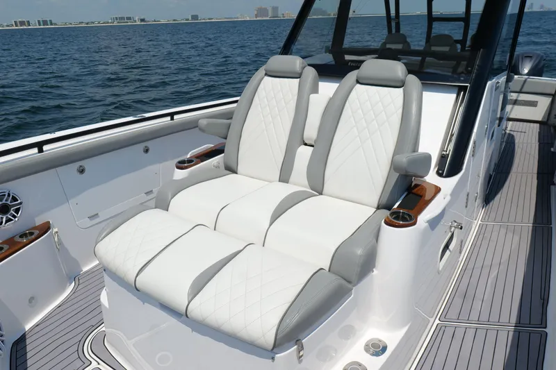 Slide: The Image of 2024 Everglades 395 Center Console boat with luxurious seating on open water. - 49