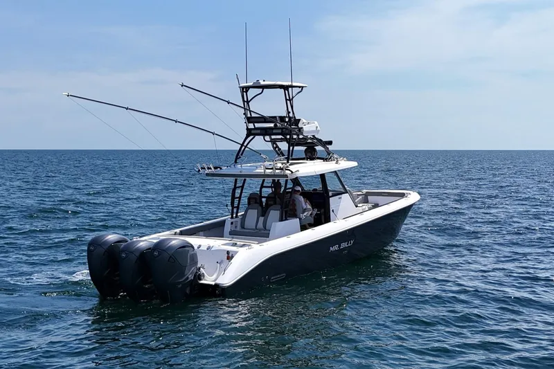 Slide: The Image of 2024 Everglades 395 Center Console boat on open sea, featuring triple outboard engines. - 5