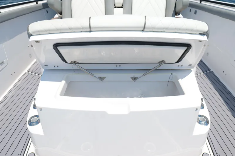 Slide: The Image of 2024 Everglades 395 Center Console boat with open storage compartment and cushioned seating. - 51