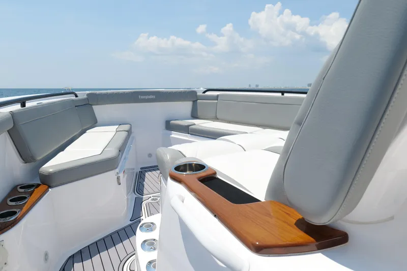 Slide: The Image of 2024 Everglades 395 Center Console boat interior with luxurious seating and cup holders. - 52