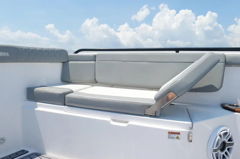 Slide: The Image of 2024 Everglades 395 Center Console boat seating with adjustable backrest under a blue sky. - 54