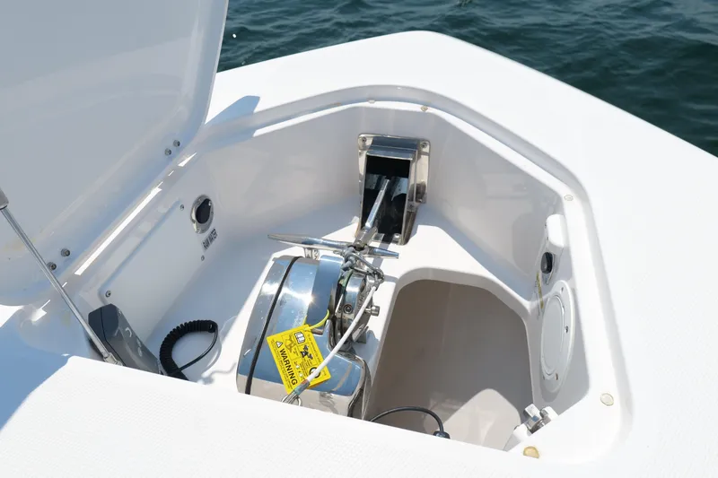 Slide: The Image of 2024 Everglades 395 Center Console anchor compartment with open hatch, showcasing marine equipment. - 56