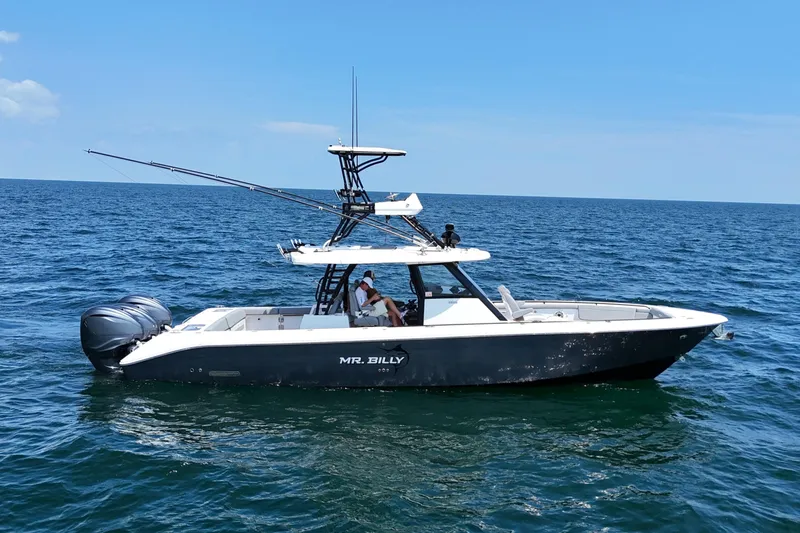 Slide: The Image of 2024 Everglades 395 Center Console boat on open sea under clear blue sky. - 6