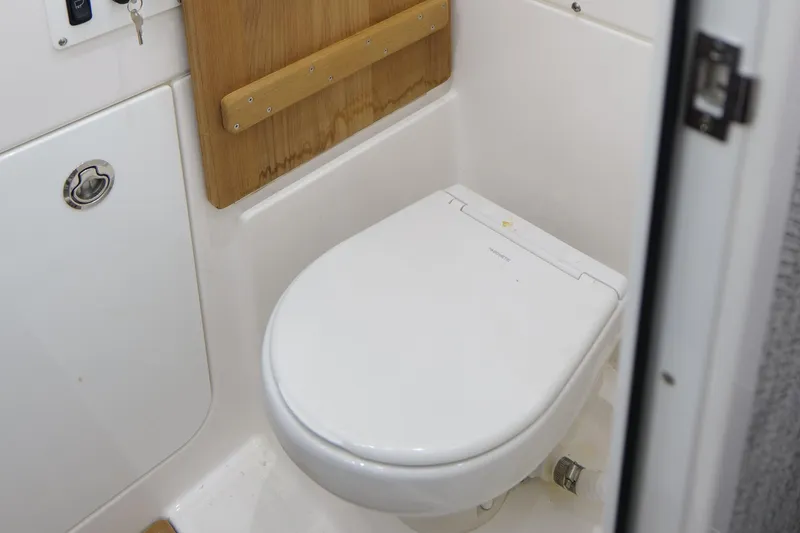 Slide: The Image of 2024 Everglades 395 Center Console boat bathroom with modern toilet design. - 61