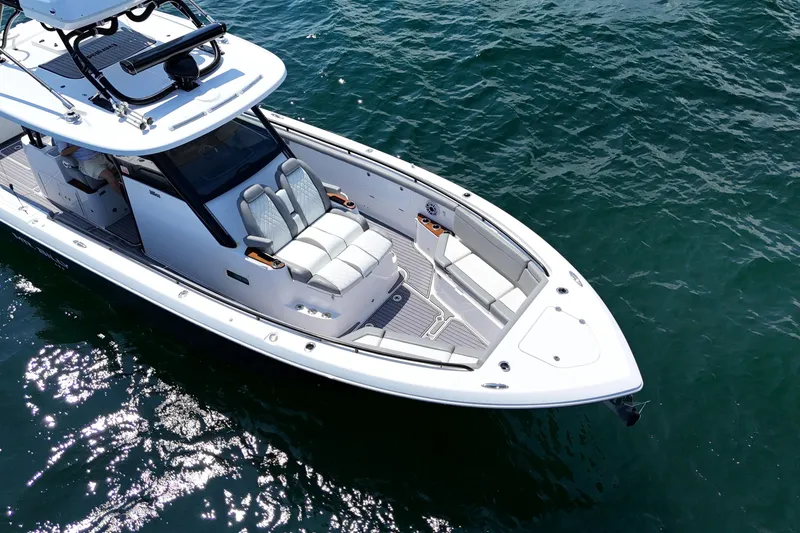 Slide: The Image of 2024 Everglades 395 Center Console boat on clear blue water, showcasing sleek design. - 62