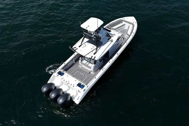 Slide: The Image of 2024 Everglades 395 Center Console boat cruising on open water. - 64