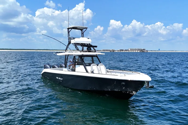 Slide: The Image of 2024 Everglades 395 Center Console boat on open water under blue sky. - 7