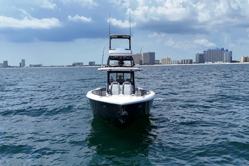 Slide: The Image of 2024 Everglades 395 Center Console boat on open water with city skyline. - 8