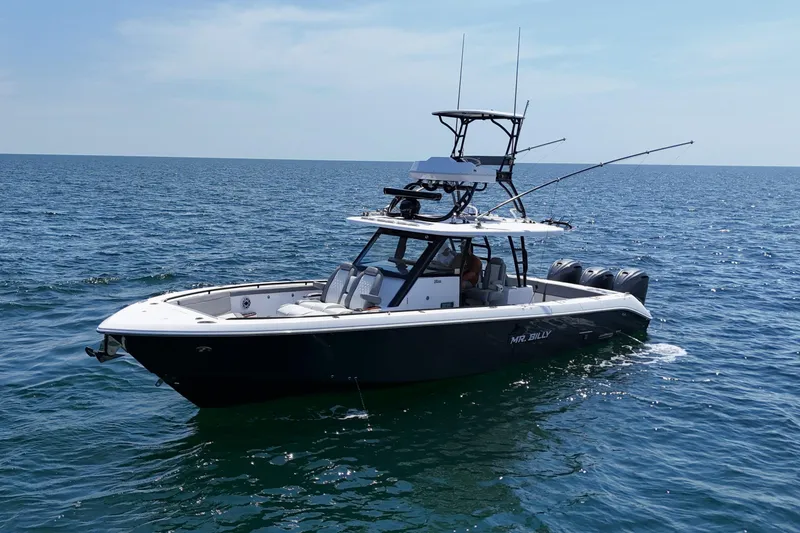 Slide: The Image of 2024 Everglades 395 Center Console boat on open water, clear sky. - 9