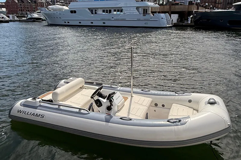 Slide: The Image of 2021 Williams Jet Tenders SportJet 395 in marina, with yachts in background. - 2