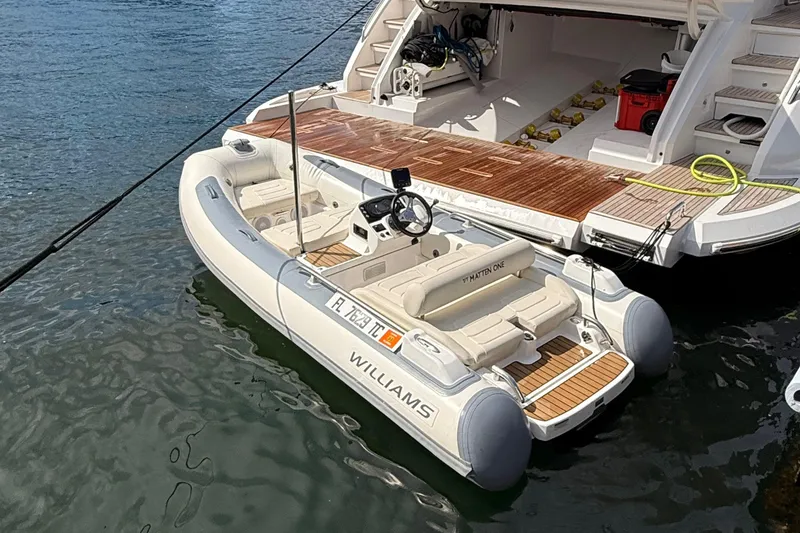 Slide: The Image of 2021 Williams Jet Tenders SportJet 395 docked beside a yacht on calm water. - 3