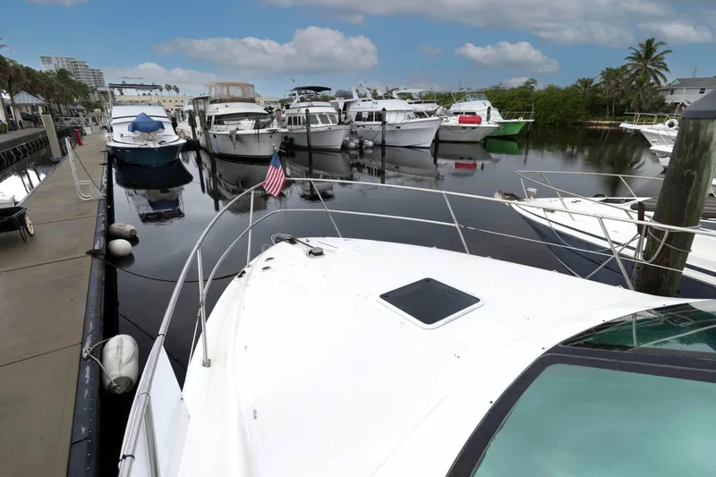 Slide: The Image of 1998 Sea Ray 370 Aft Cabin docked in a marina with other boats. - 10