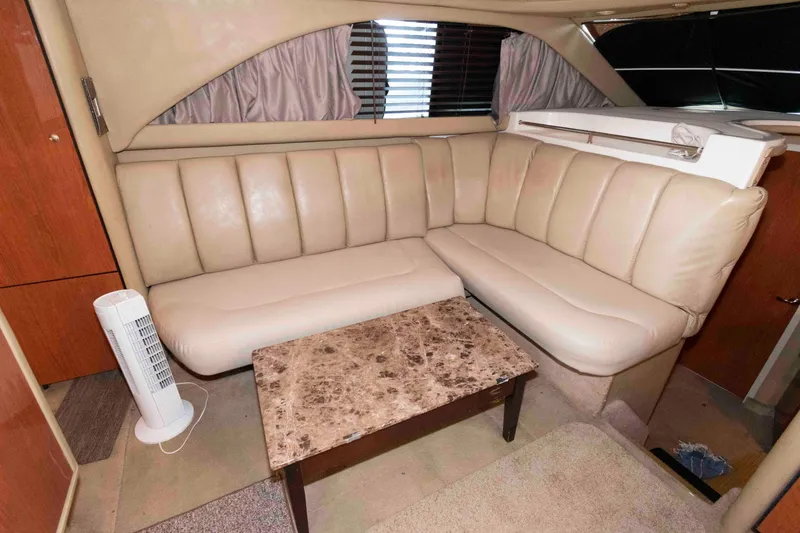 Slide: The Image of Luxurious interior of 1998 Sea Ray 370 Aft Cabin with beige leather seating and marble table. - 14