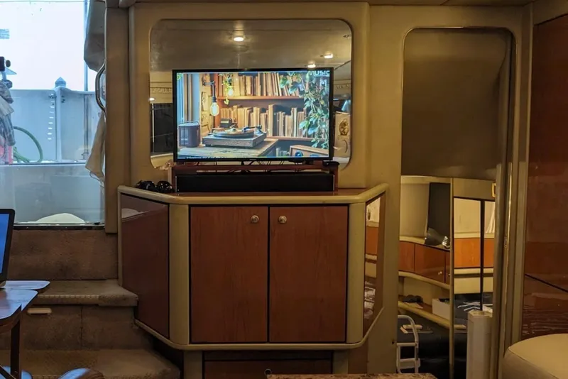 Slide: The Image of Interior of 1998 Sea Ray 370 Aft Cabin with TV and wooden cabinetry. - 15