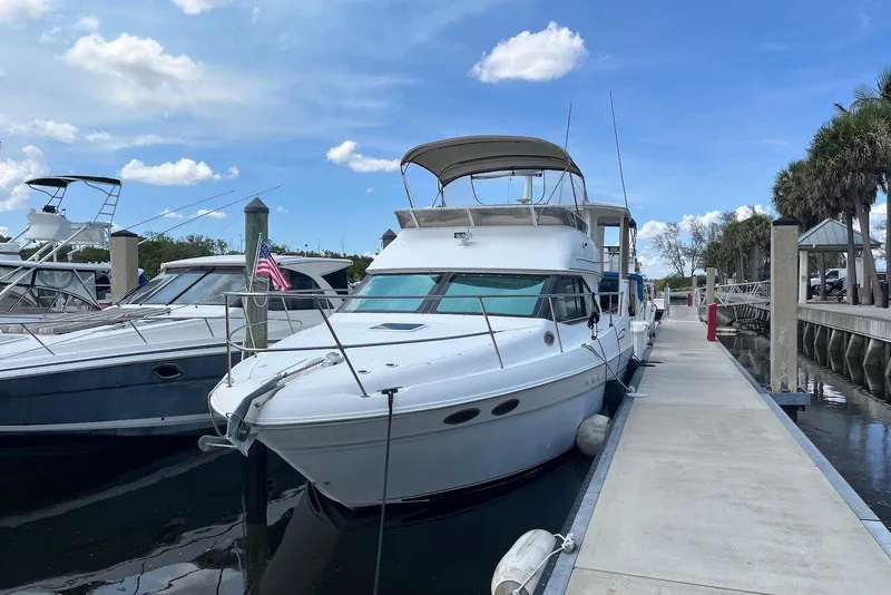 Slide: The Image of 1998 Sea Ray 370 Aft Cabin yacht docked at marina under blue sky. - 2