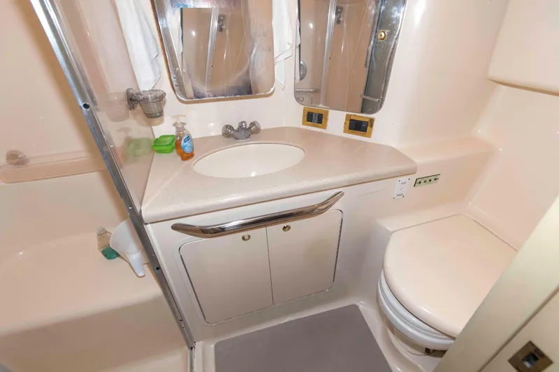 Slide: The Image of 1998 Sea Ray 370 Aft Cabin bathroom with sink, mirror, and toilet. - 21
