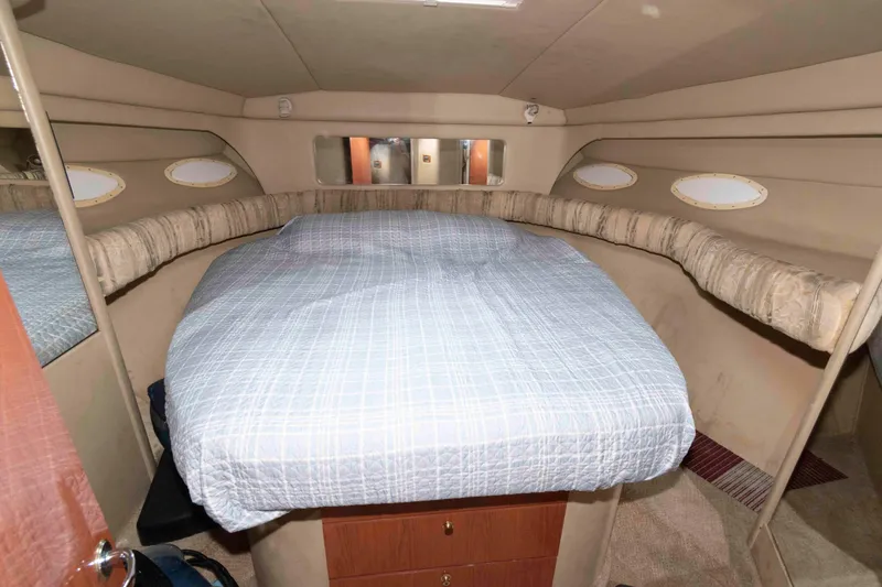 Slide: The Image of Cozy cabin interior of 1998 Sea Ray 370 Aft Cabin with bed and portholes. - 24