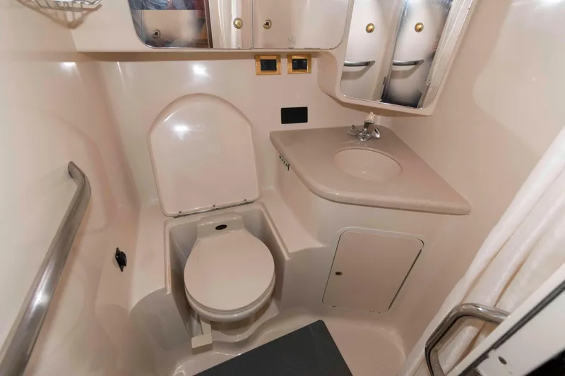 Slide: The Image of 1998 Sea Ray 370 Aft Cabin bathroom with toilet, sink, and storage cabinets. - 25