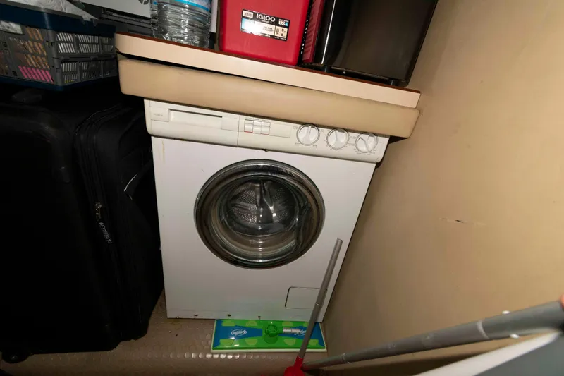 Slide: The Image of Compact laundry area on 1998 Sea Ray 370 Aft Cabin yacht with washing machine. - 26