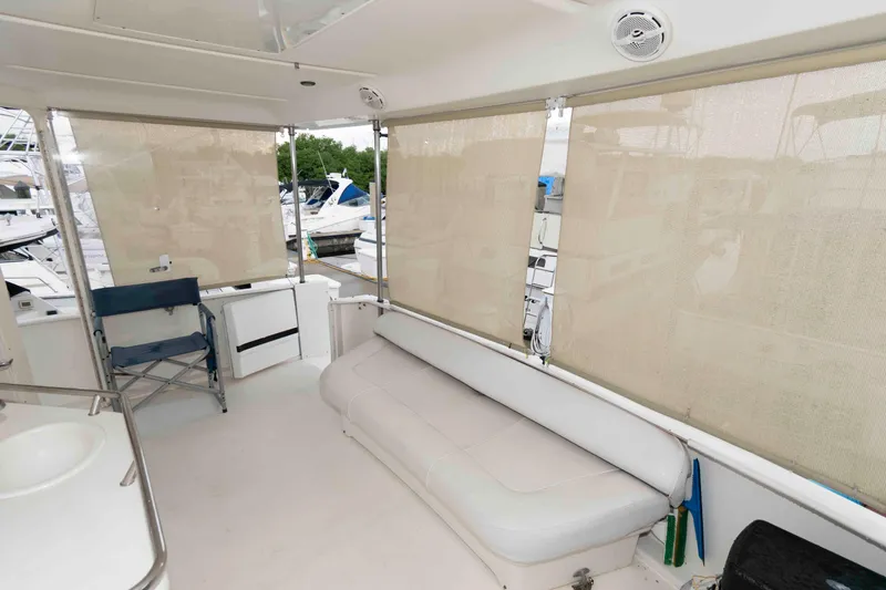 Slide: The Image of 1998 Sea Ray 370 Aft Cabin interior with seating and window shades. - 3