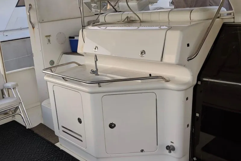 Slide: The Image of 1998 Sea Ray 370 Aft Cabin yacht interior with sink and storage area. - 4