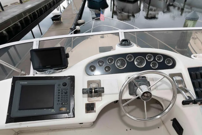 Slide: The Image of 1998 Sea Ray 370 Aft Cabin helm with navigation equipment and steering wheel. - 6