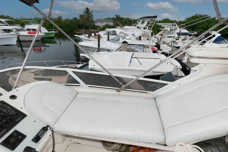 Slide: The Image of 1998 Sea Ray 370 Aft Cabin yacht docked among other boats in a marina. - 8