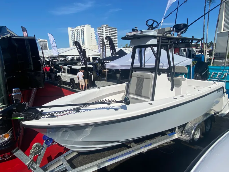 The Image of Reef Runner 230 c boat 2026 on calm water with palm trees in background. - 0