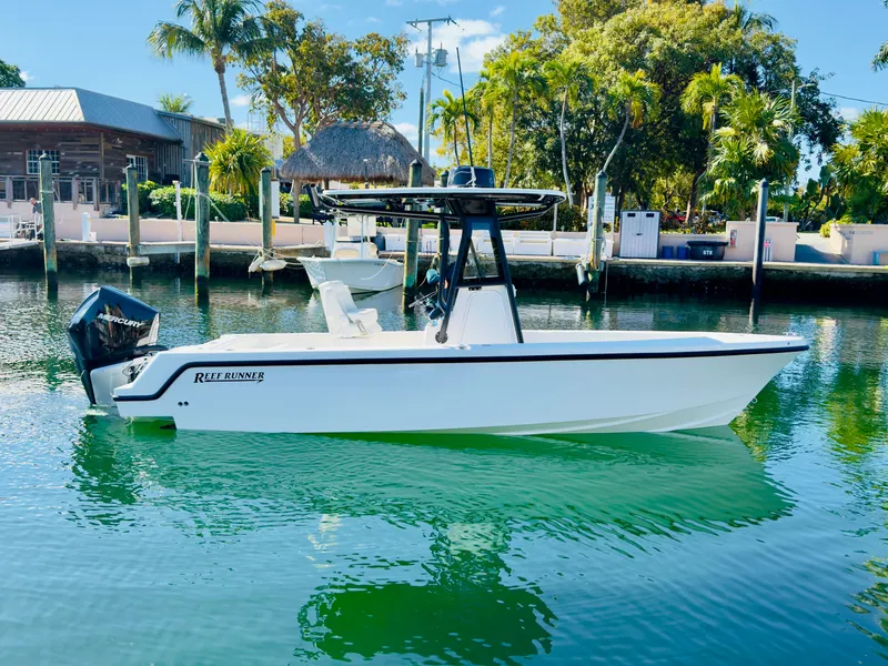 Slide: The Image of 2026 Reef Runner 230 c boat on calm water. - 12