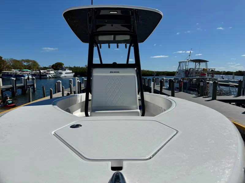 Slide: The Image of Reef Runner 230 c boat at dock, sunny day, 2026 model. - 16