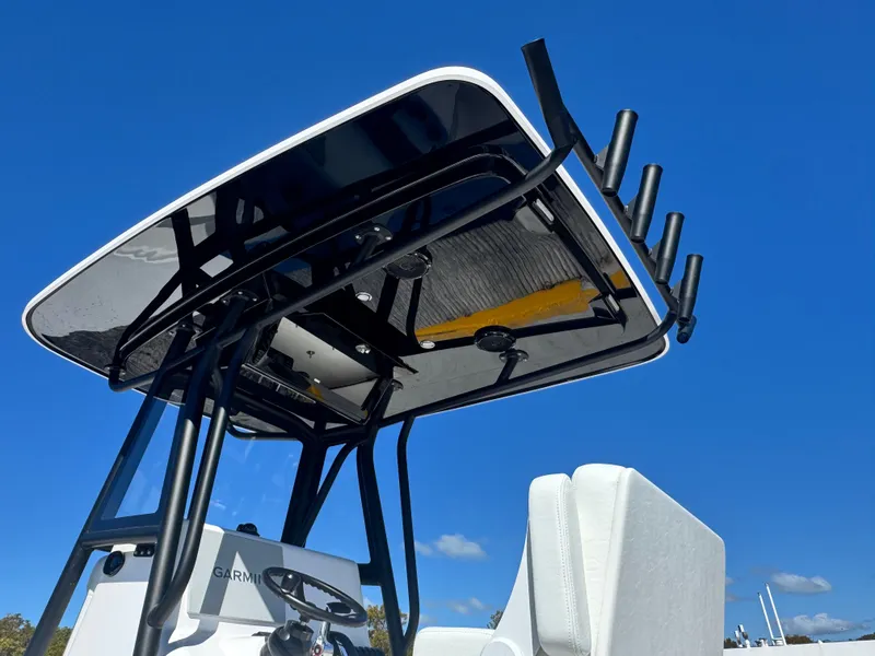 Slide: The Image of Reef Runner 230 c 2026 boat with T-top and rod holders. - 17